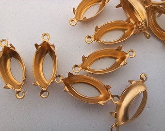 May include: Gold-toned metal oval-shaped pendant settings with three prongs on each side. The settings have a loop on the top for attaching a chain or cord.