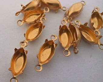 May include: A group of 10 gold-toned metal oval-shaped settings for cabochons. Each setting has two loops on the side for attaching to jewelry.