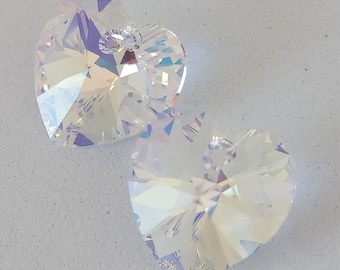 May include: Two iridescent clear crystal heart-shaped charms with a hole at the top for hanging.
