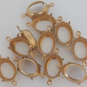 Peut inclure: Un ensemble de dix sertis ovales en métal doré pour la fabrication de bijoux. Les sertis ont une finition lisse et sont conçus pour contenir des cabochons ou d'autres pierres à dos plat.