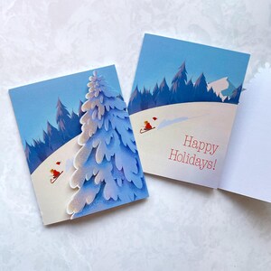 Fijne feestdagen Winter Wonderland Rodelen-wenskaart met dennenboom van gesneden papier