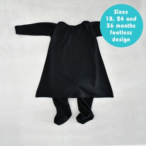 May include: Black footed pajamas for babies in sizes 18, 24, and 36 months. The pajamas are footless and have a long-sleeved top with a round neckline.