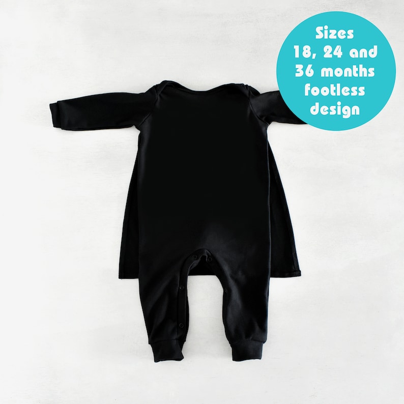 May include: Black long-sleeve footed sleeper with a cape back. Sizes 18, 24 and 36 months. Footless design.