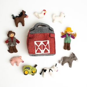 May include: A felt farm playset with a red barn, a farmer, a cow, a pig, a donkey, a horse, a cat, and a chicken. The set is perfect for imaginative play.