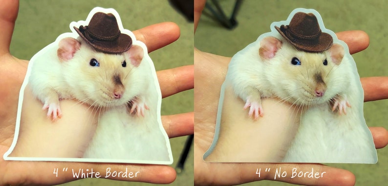 May include: A 4-inch white rat wearing a brown cowboy hat. The rat is sitting on a hand. The sticker has a white border.