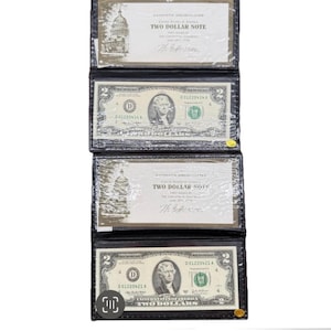 May include: Four authentic uncirculated two-dollar bills in protective black holders. Each bill features a portrait of Thomas Jefferson and a depiction of the U.S. Capitol building. The bills are from the United States of America.