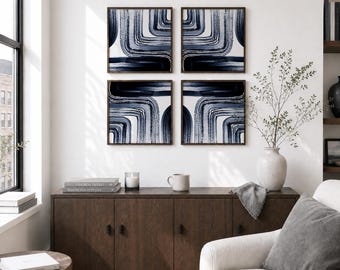 May include: A set of four square wall art pieces featuring abstract navy blue and white brushstroke patterns in dark wood frames, arranged in a grid above a dark brown wooden sideboard with four doors and black hardware handles.