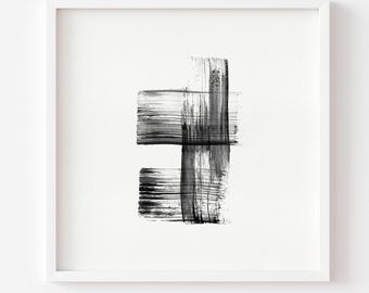 May include: A square white frame containing a black ink painting on a white background. The artwork features two horizontal brushstrokes intersected by a single vertical brushstroke, creating a textured, layered, and abstract composition.