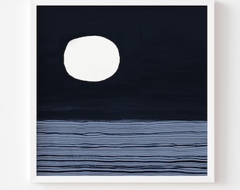 May include: Abstract art print in a white frame. The artwork features a white oval shape against a dark navy blue background, with horizontal blue lines at the bottom. The text at the bottom reads "Print comes Unframed (no frame or matt included)".