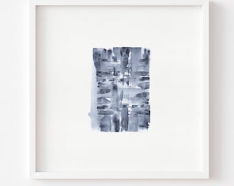 May include: Abstract watercolor painting in a white frame. The artwork features a rectangular composition of overlapping blue and gray brushstrokes. The painting is mounted on a white background.