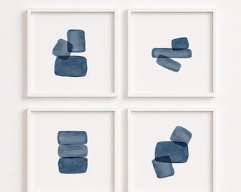May include: A set of four square wall art prints in white frames, each featuring abstract watercolor shapes in shades of navy blue. The compositions display various arrangements of rounded rectangular forms layered against a plain white background.