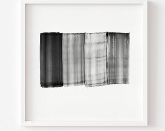 May include: A framed abstract art print featuring four vertical brushstrokes in varying shades of gray and black. The artwork is displayed in a white square frame against a white background, creating a minimalist aesthetic.