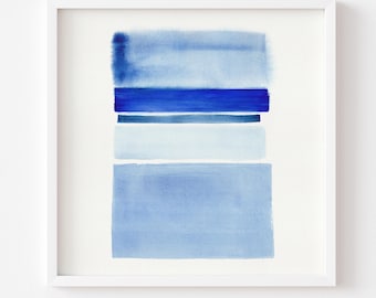 May include: Abstract watercolor print in a white frame. The artwork features horizontal bands of varying shades of blue, from light to dark, creating a minimalist and modern aesthetic. The text at the bottom reads "Print comes Unframed (no frame or matt included)".