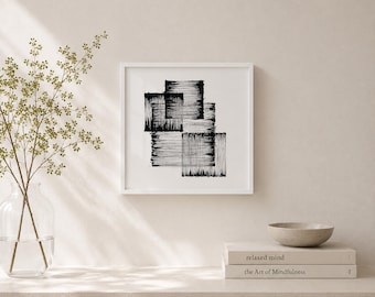 May include: Square white framed art print featuring a black abstract design of overlapping rectangular shapes with textured, linear strokes. The artwork is displayed on a neutral-toned wall, with a vase of greenery and a small bowl nearby.