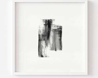 May include: A square white frame containing a piece of art with black and gray brushstrokes. The paint is applied in vertical and horizontal layers, creating a textured, abstract composition centered on a plain white background within the frame.