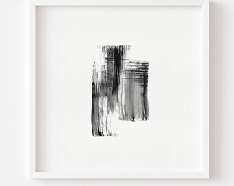 May include: Abstract art print in a white frame. The artwork features bold black brushstrokes on a white background. The composition includes two overlapping rectangular shapes, creating a modern and minimalist aesthetic.