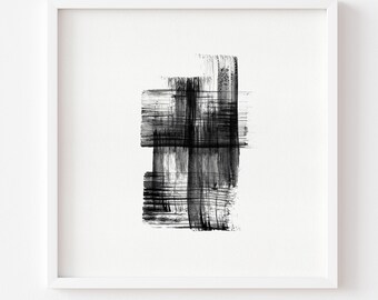 May include: Abstract black and white artwork in a white frame. The art features bold brushstrokes creating a layered, textured effect. The composition is a study in contrasts, with the dark strokes against a bright white background.