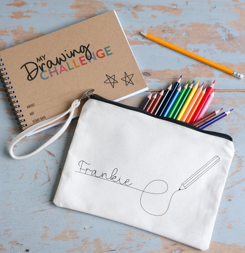 Drawing challenge sketch book with 52 prompts. Comes in a personalised canvas pouch and a set of coloured pencils