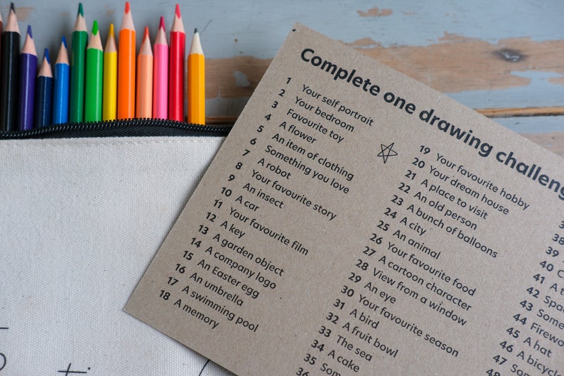 personalised sketchbook kit with 52 drawing prompts written on the inside front cover