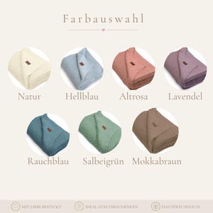 May include: A color selection chart titled Farbauswahl displaying seven folded knit blankets in natural, light blue, dusty pink, lavender, smoky blue, sage green, and mocha brown, each featuring a small brown rectangular brand tag.