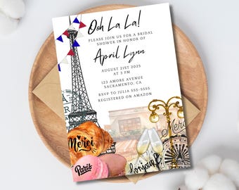 May include: Bridal shower invitation with a Parisian theme. The invitation features the Eiffel Tower, croissants, macarons, and the words "Ooh La La!" and "Paris". The invitation is on a white background.