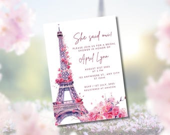 May include: Bridal shower invitation featuring the Eiffel Tower adorned with pink roses. The invitation includes the text "She said oui!" and details for the event, including the date, time, and location. The invitation is decorated with floral accents.