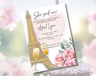 May include: Bridal shower invitation with the text "She said oui!" featuring a gold Eiffel Tower illustration, champagne glasses, and pink roses. The invitation includes the name "April Lynn" and event details.