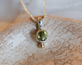 Silver and green garnet pendant with a yellow gold ball