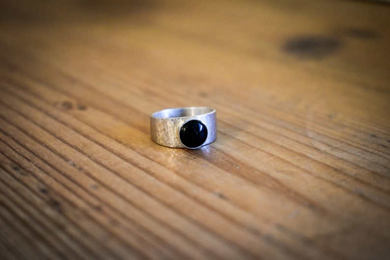 Wide silver ring set with a shiny Onyx shiny dented