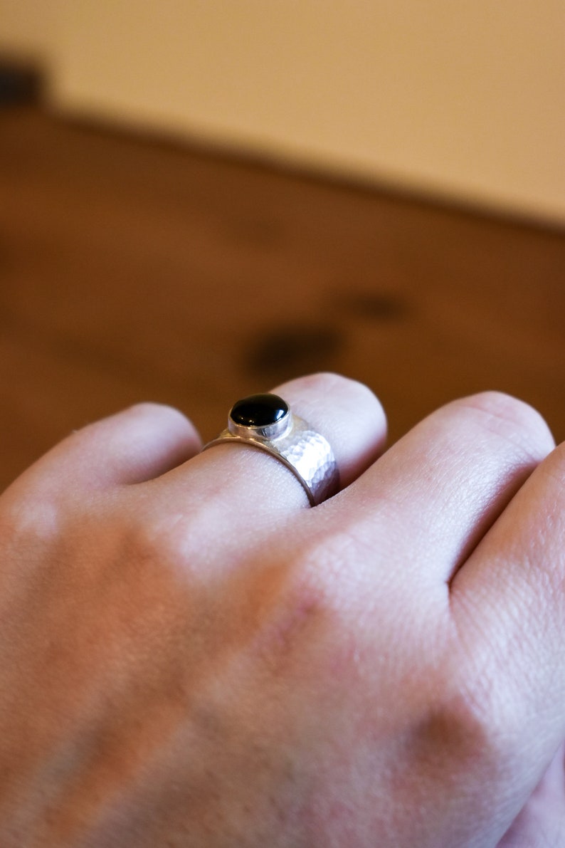 Wide silver ring set with a shiny Onyx shiny dented