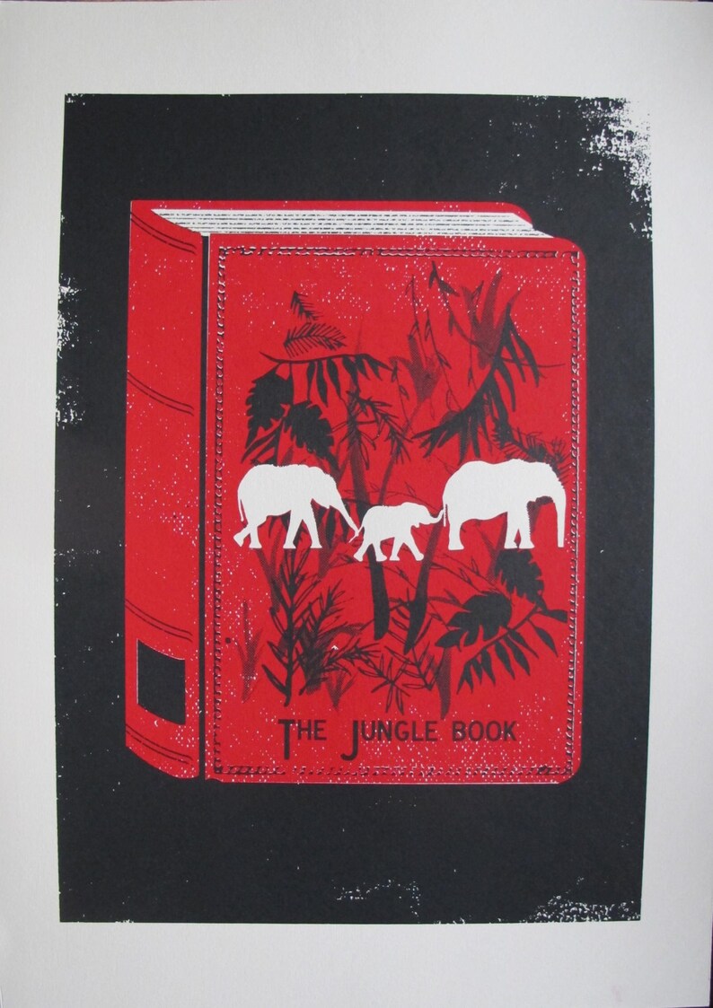 May include: A red book with a black and white illustration of elephants and jungle foliage. The title of the book is "The Jungle Book".