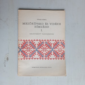 May include: A vintage book cover with the title "Mezőkövesd és vidéke Hímzései I. Szalánvarrott vászonhímzések" in Hungarian. The cover features a red and blue geometric pattern.