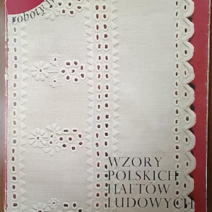 May include: A book cover with a white background and red border. The cover features a white embroidered design and the text "WZORY POLSKICH HAFTÓW LUDOWYCH" and "haft rzeszowski".