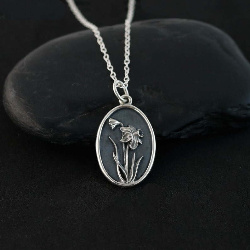 a necklace with a daffodil on it