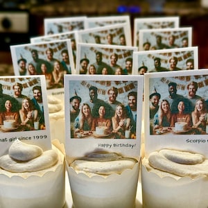 May include: A group of cupcakes decorated with white frosting and personalized images. The images feature a group of friends celebrating a birthday with the text "Happy Birthday!" and "Scorpio & that girl since 1999".