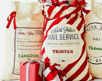May include: Three red and white striped Santa sacks with personalized labels. The labels read "North Pole Mail Service" with the names "Tristan", "Cameron", and "Victoria".