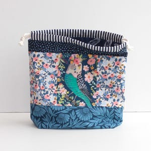 May include: A rustic wooden sign with the text "Welcome to our home" in white lettering. The sign features a distressed finish and a simple, inviting design, perfect for a front porch or entryway.