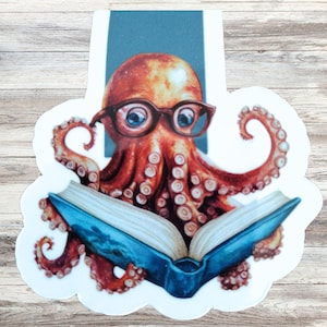 May include: A sticker depicting an octopus wearing spectacles and reading a book. The octopus is orange and brown, with blue eyes and a blue book. The sticker has a white border and a blue background.