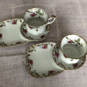 May include: Two sets of vintage teacups and saucers with floral designs. Each set includes a small plate for snacks or sandwiches.