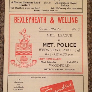 May include: A vintage advertisement for Wally Saunders, a bookmaker, featuring a red and white crest with a horse and a tree. The ad also includes information about the Bexleyheath & Welling football club, including their upcoming match against Met. Police on August 23rd, 1961.