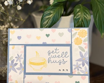 Pastel Get Well Hugs card with flowers and hearts