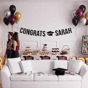 May include: A graduation party scene with balloons, a banner reading "Congrats Sarah," and a white sofa. A table displays a cake, cupcakes, and snacks. A framed photo collage and illuminated "PARTY" letters add to the festive atmosphere.