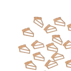 May include: A collection of glittery, light brown pie slice shapes against a white background. The pie slices have a crust design and a triangular shape, suggesting a dessert theme.
