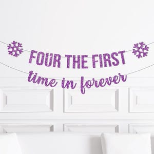 May include: A purple glitter banner with the text "FOUR THE FIRST time in forever" and snowflake accents. The banner is strung across a white wall, above a white couch. Perfect for a birthday party.