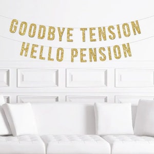 May include: A gold glitter banner with the text "Goodbye Tension Hello Pension" hanging on a white wall above a white couch with white pillows.