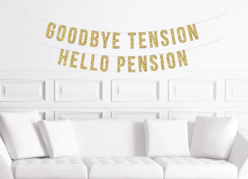 May include: A gold glitter banner with the text "Goodbye Tension Hello Pension" hanging on a white wall above a white couch with white pillows.