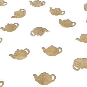 May include: Scattered on a white background are numerous gold glitter teapots. The teapots are all the same shape and size, and they are arranged in a random pattern.
