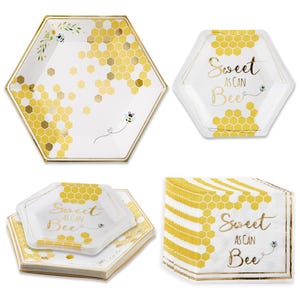 May include: Hexagon-shaped paper plates and napkins with a bee theme. The plates and napkins are white with gold honeycomb patterns and accents. The text "Sweet as can Bee" is printed on the plates and napkins. A stack of napkins is also visible.