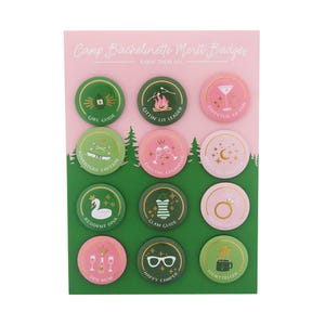 May include: A sheet of Camp Bachelorette Merit Badges with various designs and phrases like "Girl Guide" and "Director of Fun." The badges are round, with green and pink backgrounds, and gold accents. The text "Camp Bachelorette Merit Badges" is at the top.