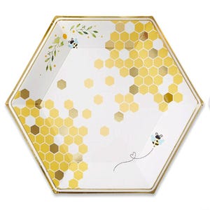 May include: A hexagonal paper plate with a gold rim and a bee-themed design. The plate features a honeycomb pattern in yellow and gold, with small bees and floral accents. The plate is white with a gold border.